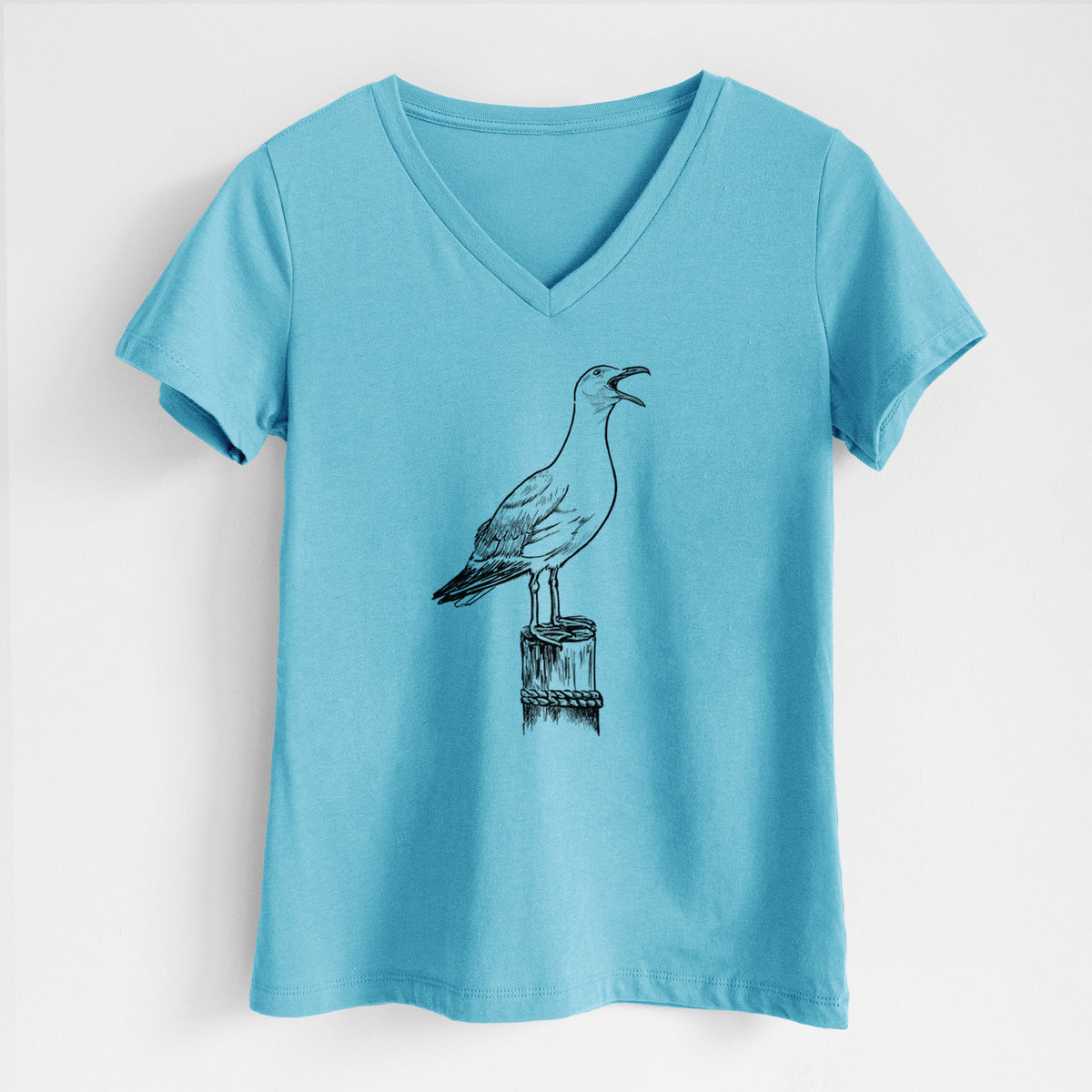 Turquoise women's relaxed fit cotton V-neck t-shirt laid flat, printed with a black ink illustration of a California gull calling from a wooden post.