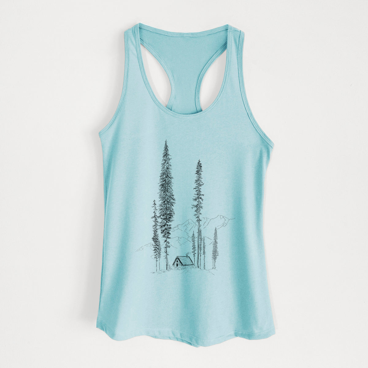 Cancun blue women's racerback tank top laid flat, printed with a black ink illustration of a small cabin nestled beneath towering pine trees.