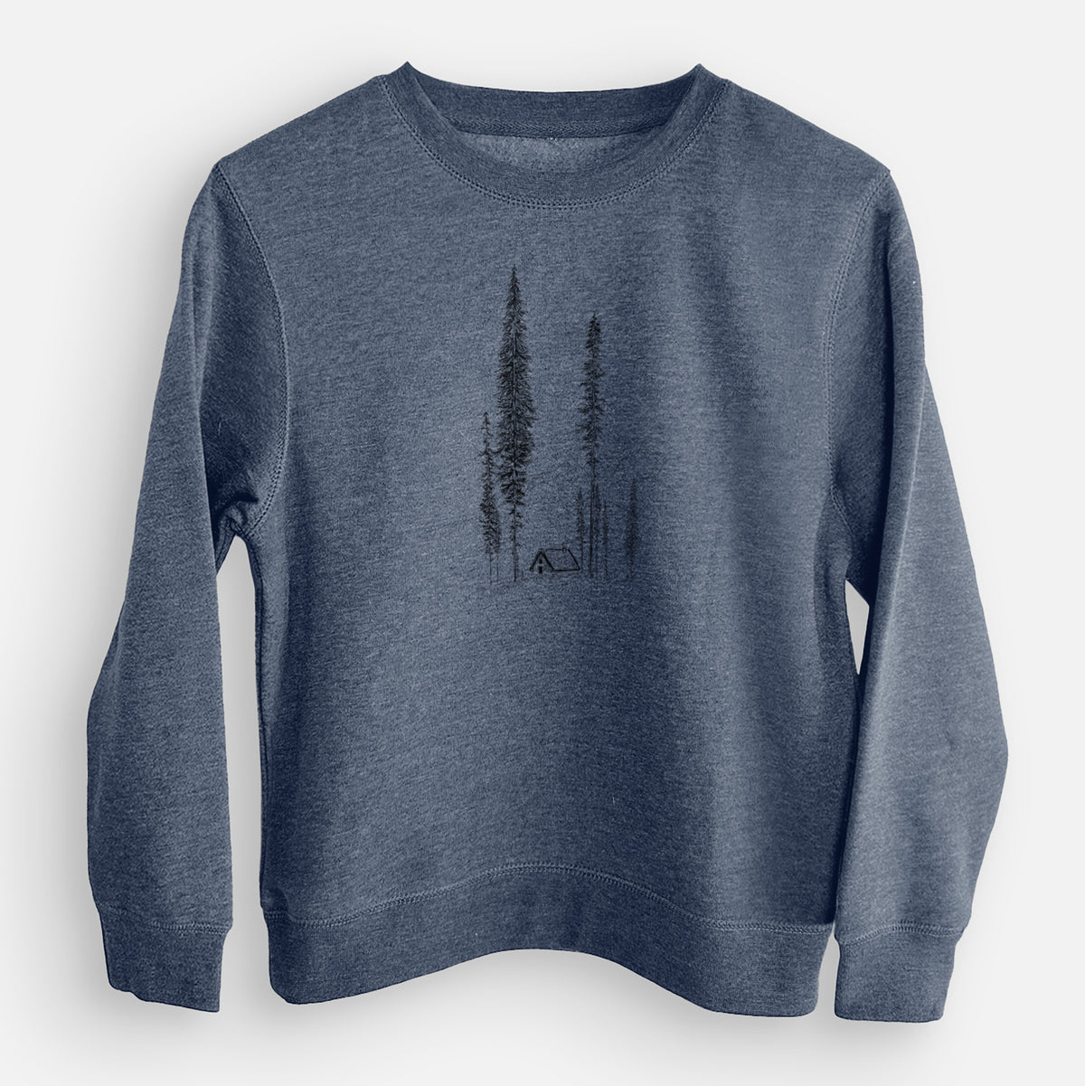 Storm blue youth crewneck sweatshirt laid flat, printed with a black ink illustration of a small cabin nestled beneath towering pine trees.