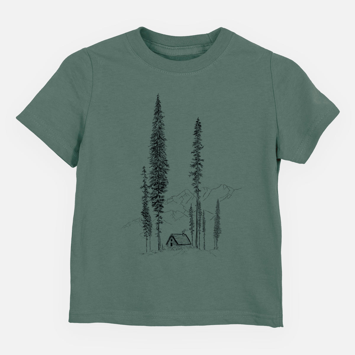 Basil green toddler t-shirt laid flat, printed with a black ink illustration of a small cabin nestled beneath towering pine trees.