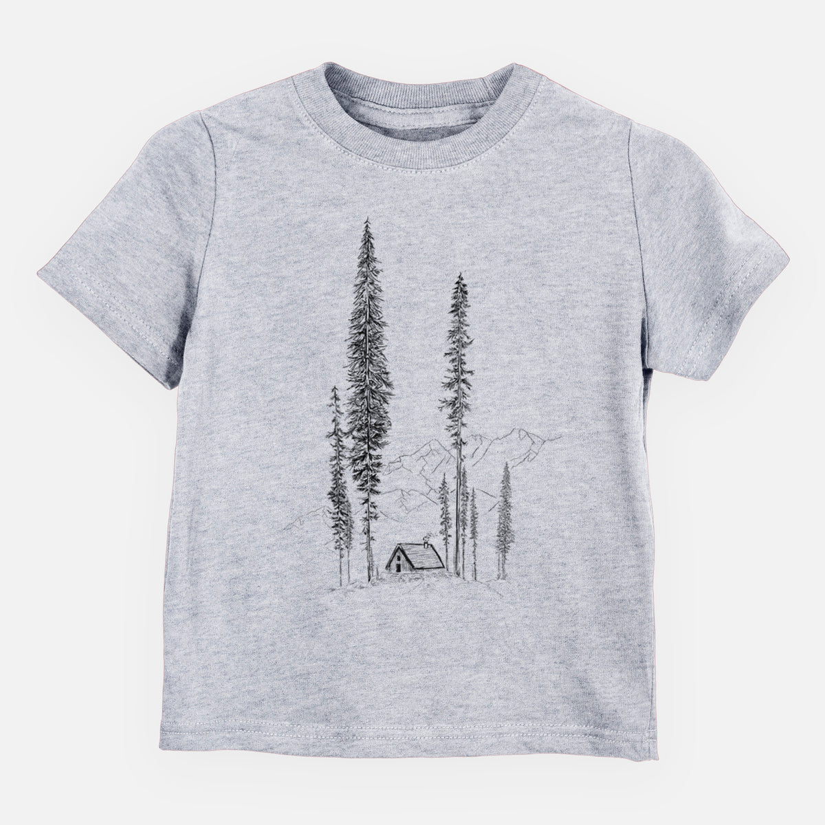 Heather grey toddler t-shirt laid flat, printed with a black ink illustration of a small cabin nestled beneath towering pine trees.