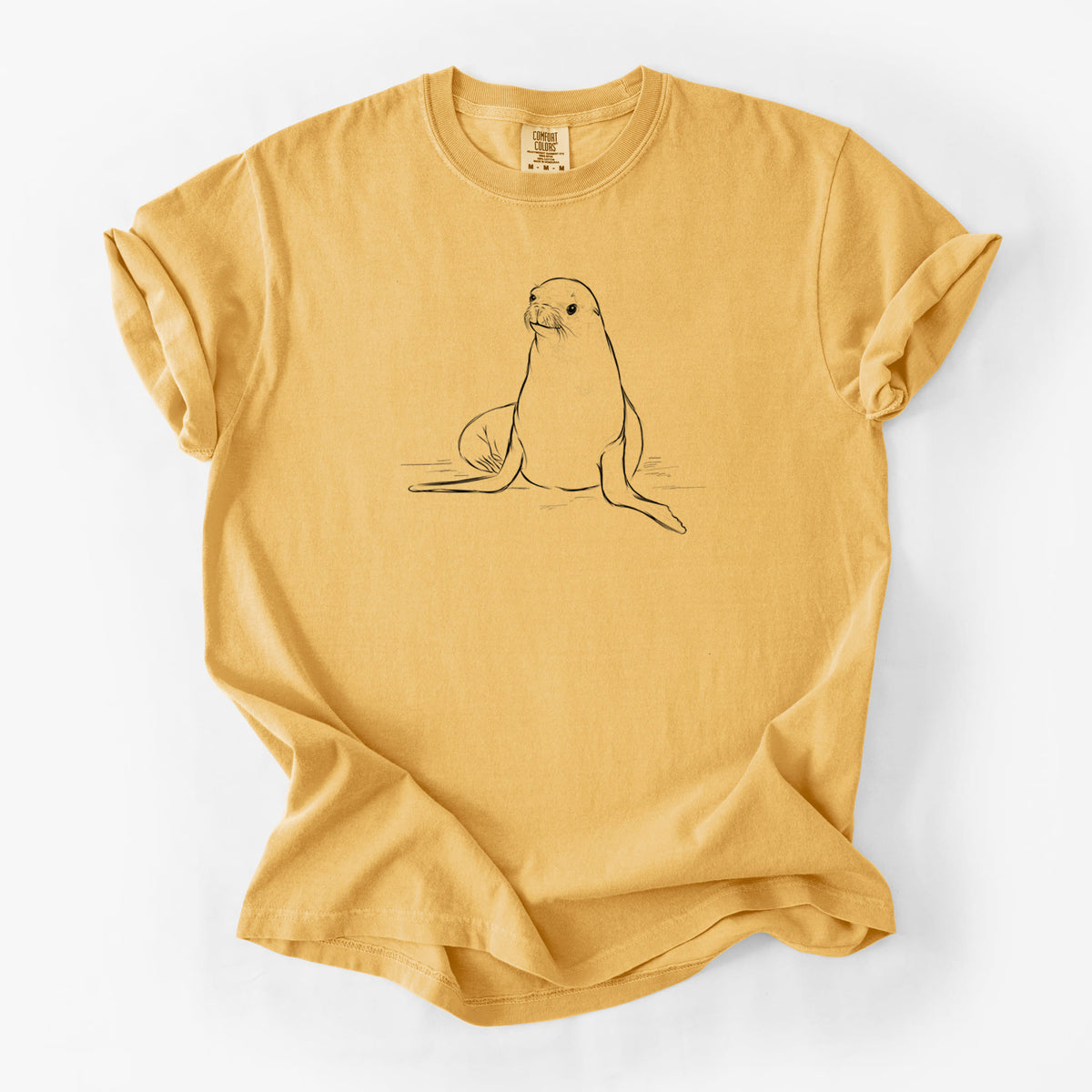Golden wheat yellow Comfort Colors t-shirt laid flat, printed with a black ink illustration of a California sea lion sitting upright.