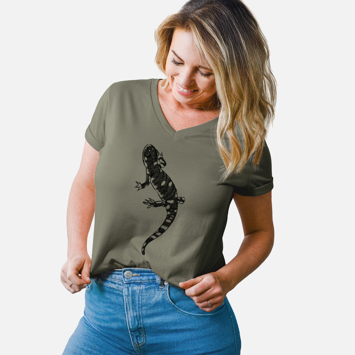 Woman wearing a military green women's relaxed fit cotton V-neck t-shirt printed with a detailed black ink illustration of a spotted California tiger salamander.