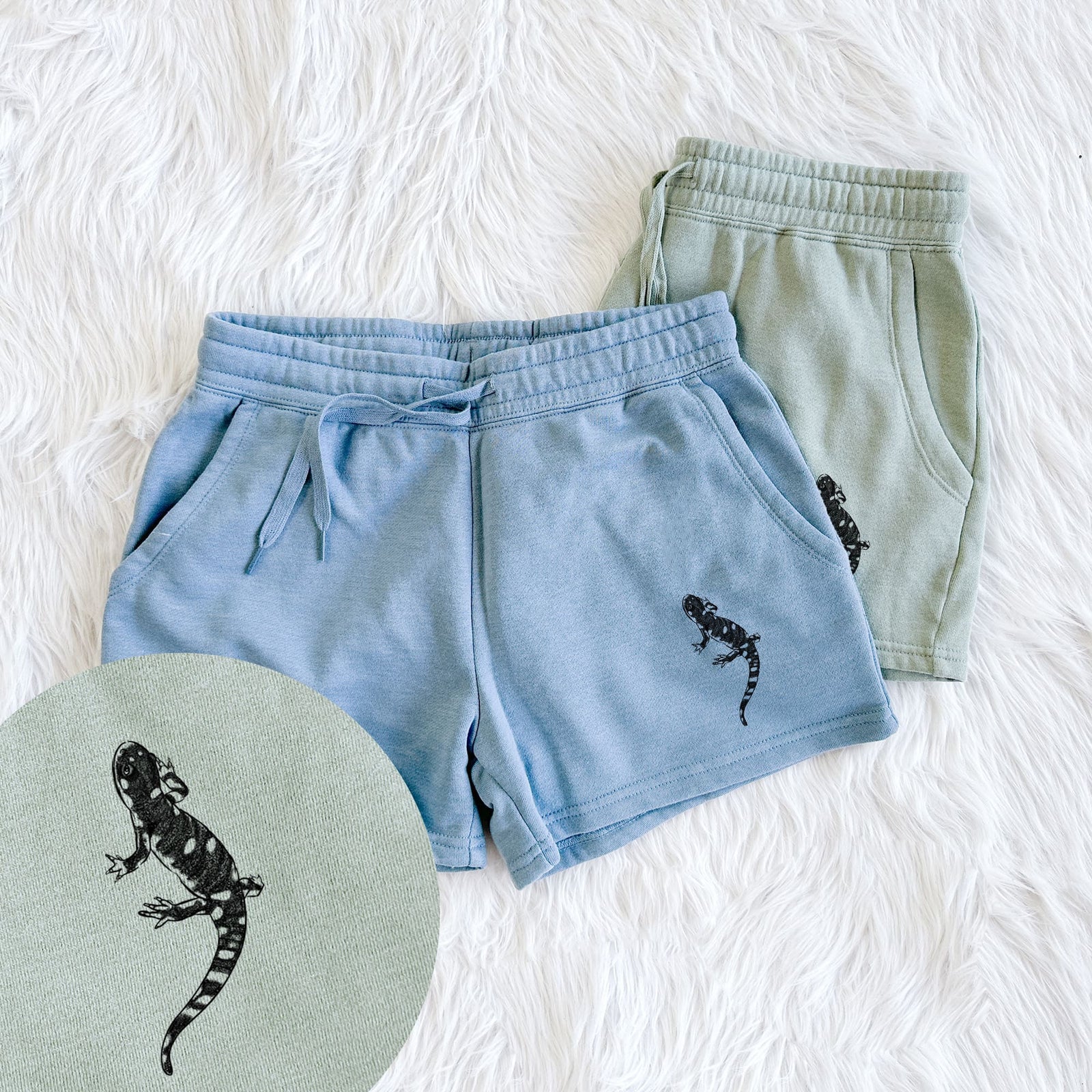 Two pairs of Cali Wave shorts in different colors printed with a detailed black ink illustration of a spotted California tiger salamander, with a close-up of the print.