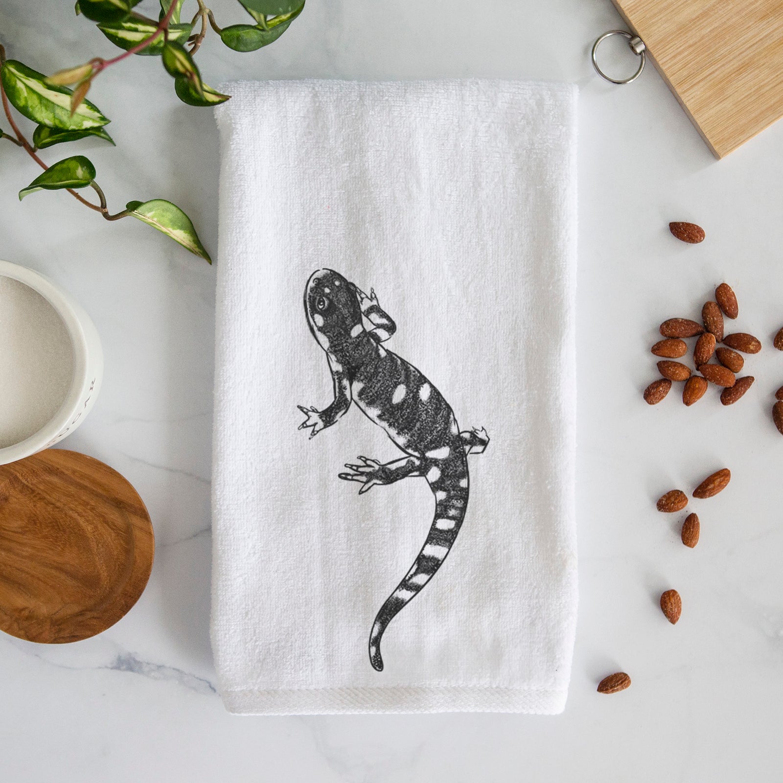 White hand towel printed with a detailed black ink illustration of a spotted California tiger salamander.
