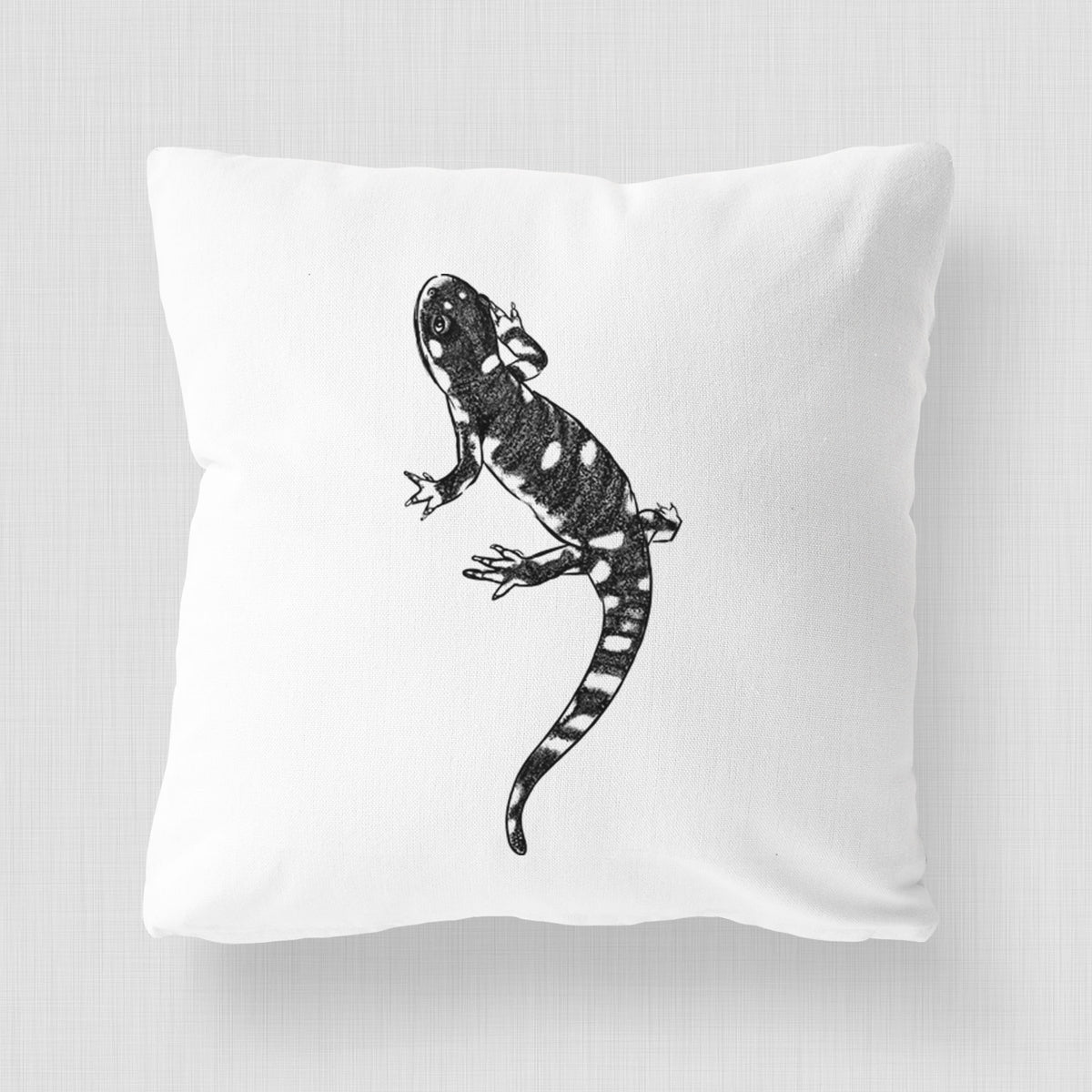 White pillow cover printed with a detailed black ink illustration of a spotted California tiger salamander.