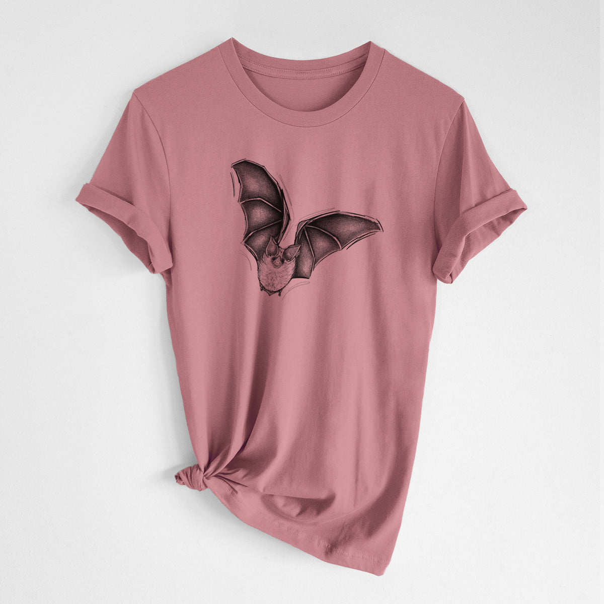 Mauve pink lightweight cotton t-shirt laid flat with the sleeves rolled, printed with a detailed black ink illustration of a California leaf-nosed bat in flight.