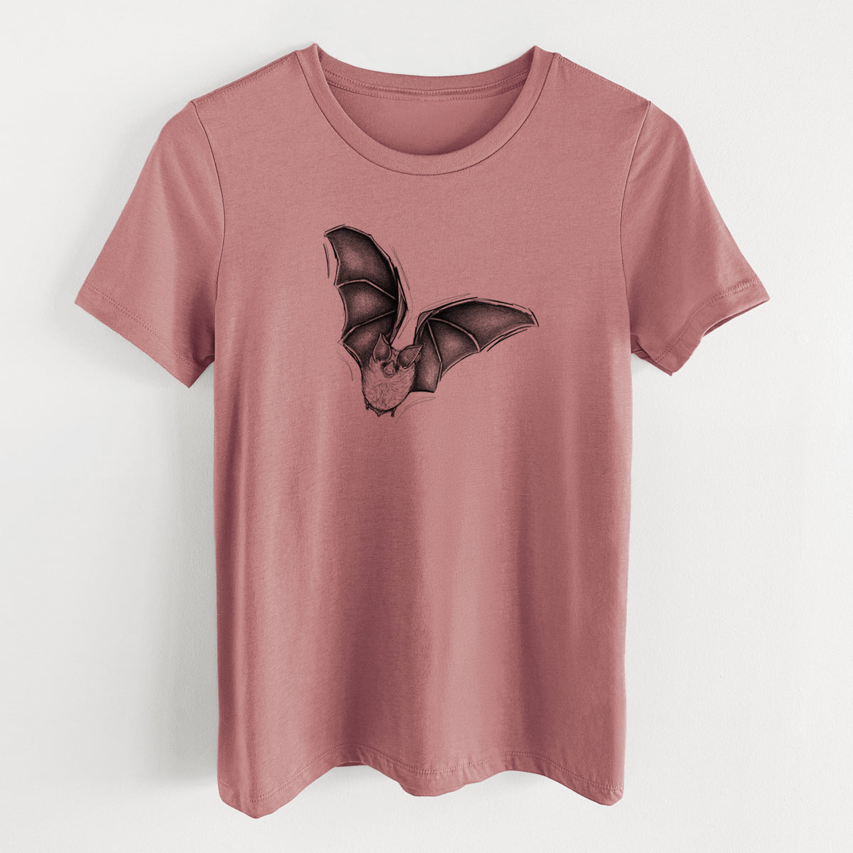 Mauve pink women's relaxed fit cotton t-shirt laid flat, printed with a detailed black ink illustration of a California leaf-nosed bat in flight.