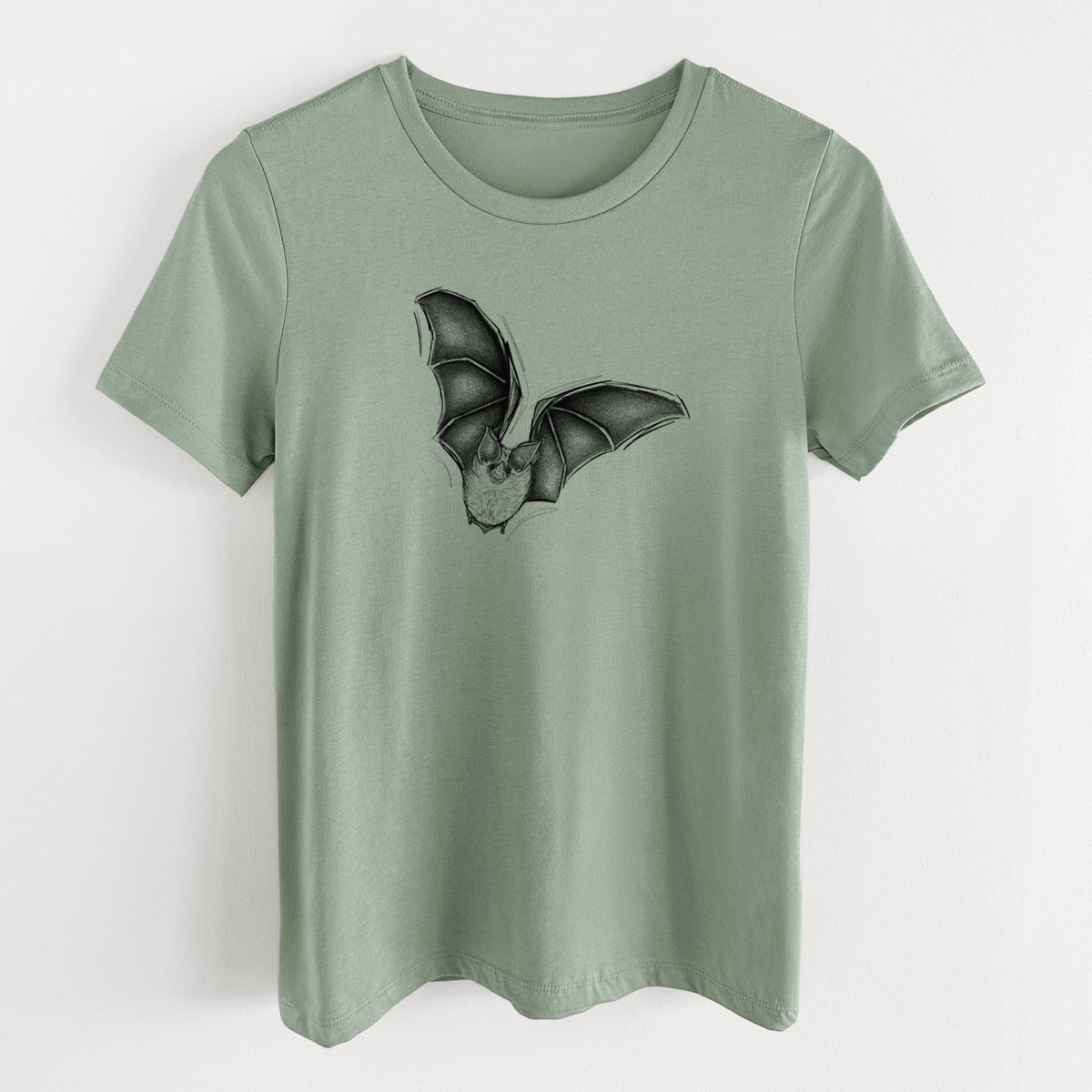 Sage green women's relaxed fit cotton t-shirt laid flat, printed with a detailed black ink illustration of a California leaf-nosed bat in flight.