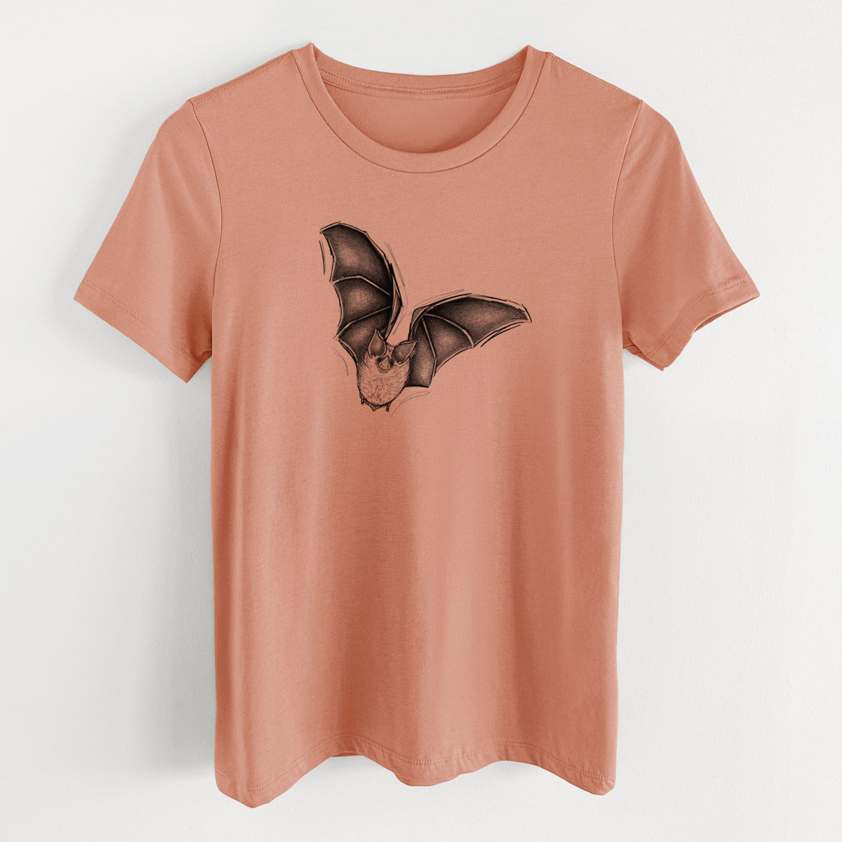 Terracotta orange women's relaxed fit cotton t-shirt laid flat, printed with a detailed black ink illustration of a California leaf-nosed bat in flight.