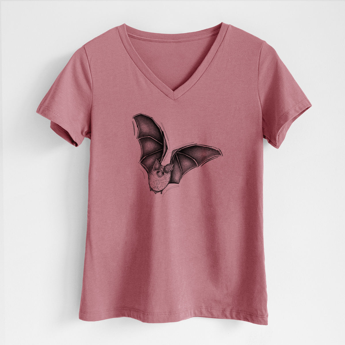 Mauve pink women's relaxed fit cotton V-neck t-shirt laid flat, printed with a detailed black ink illustration of a California leaf-nosed bat in flight.