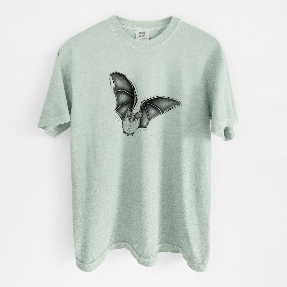 Bay green Comfort Colors t-shirt laid flat, printed with a detailed black ink illustration of a California leaf-nosed bat in flight.