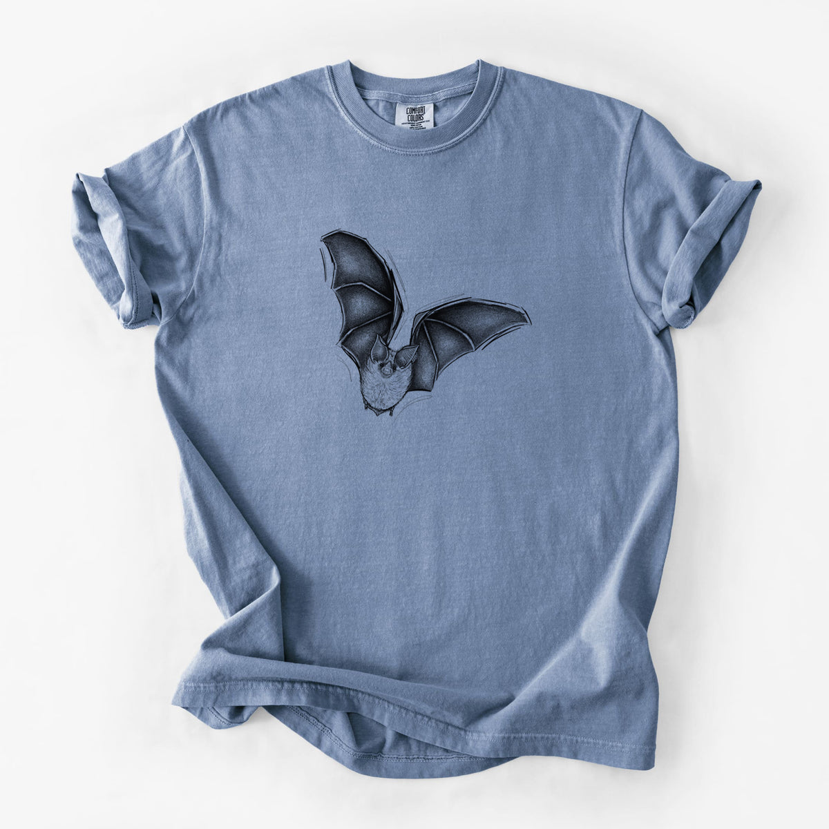 Blue jean Comfort Colors t-shirt laid flat, printed with a detailed black ink illustration of a California leaf-nosed bat in flight.