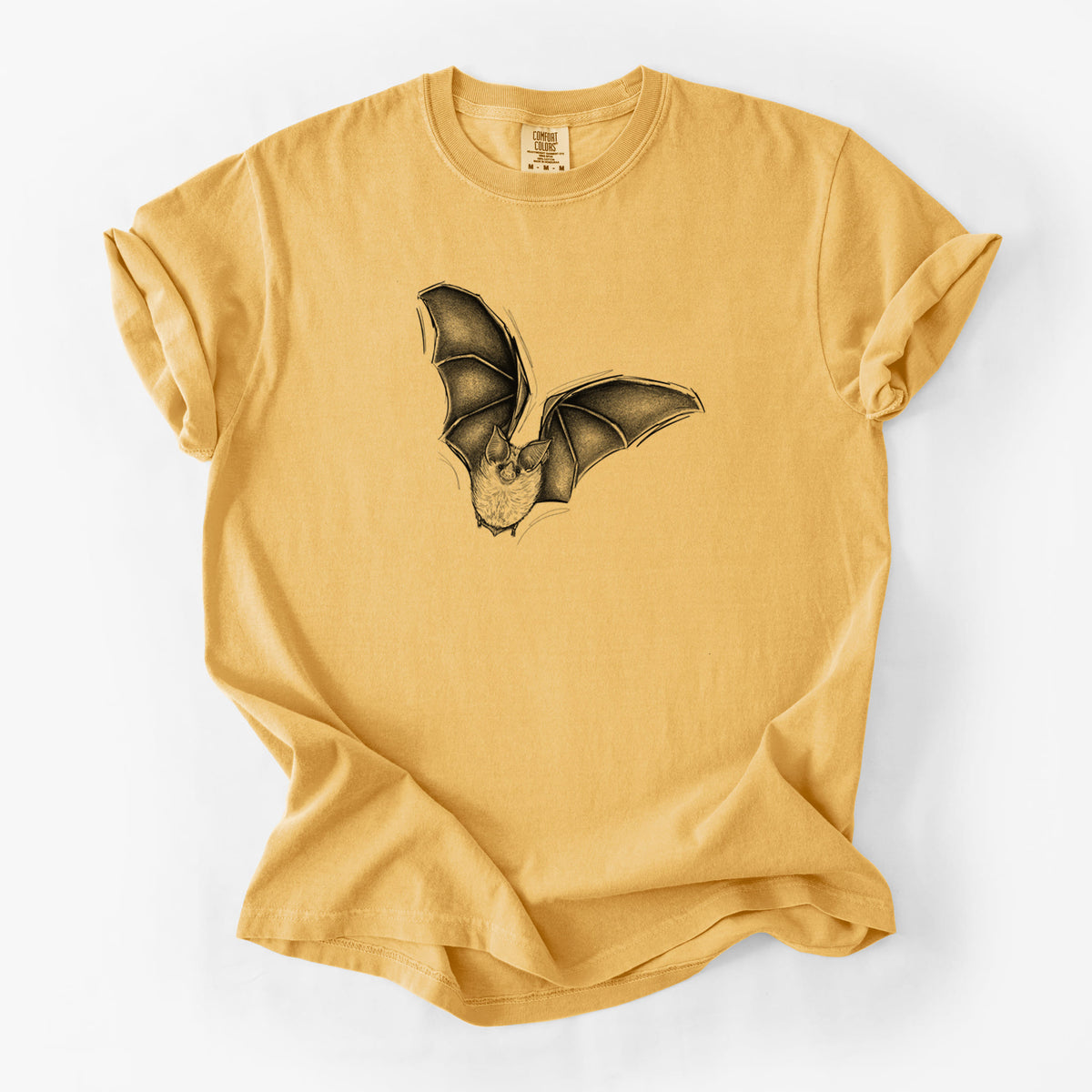 Golden wheat yellow Comfort Colors t-shirt laid flat, printed with a detailed black ink illustration of a California leaf-nosed bat in flight.