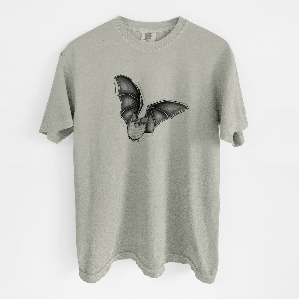 Sandstone beige Comfort Colors t-shirt laid flat, printed with a detailed black ink illustration of a California leaf-nosed bat in flight.