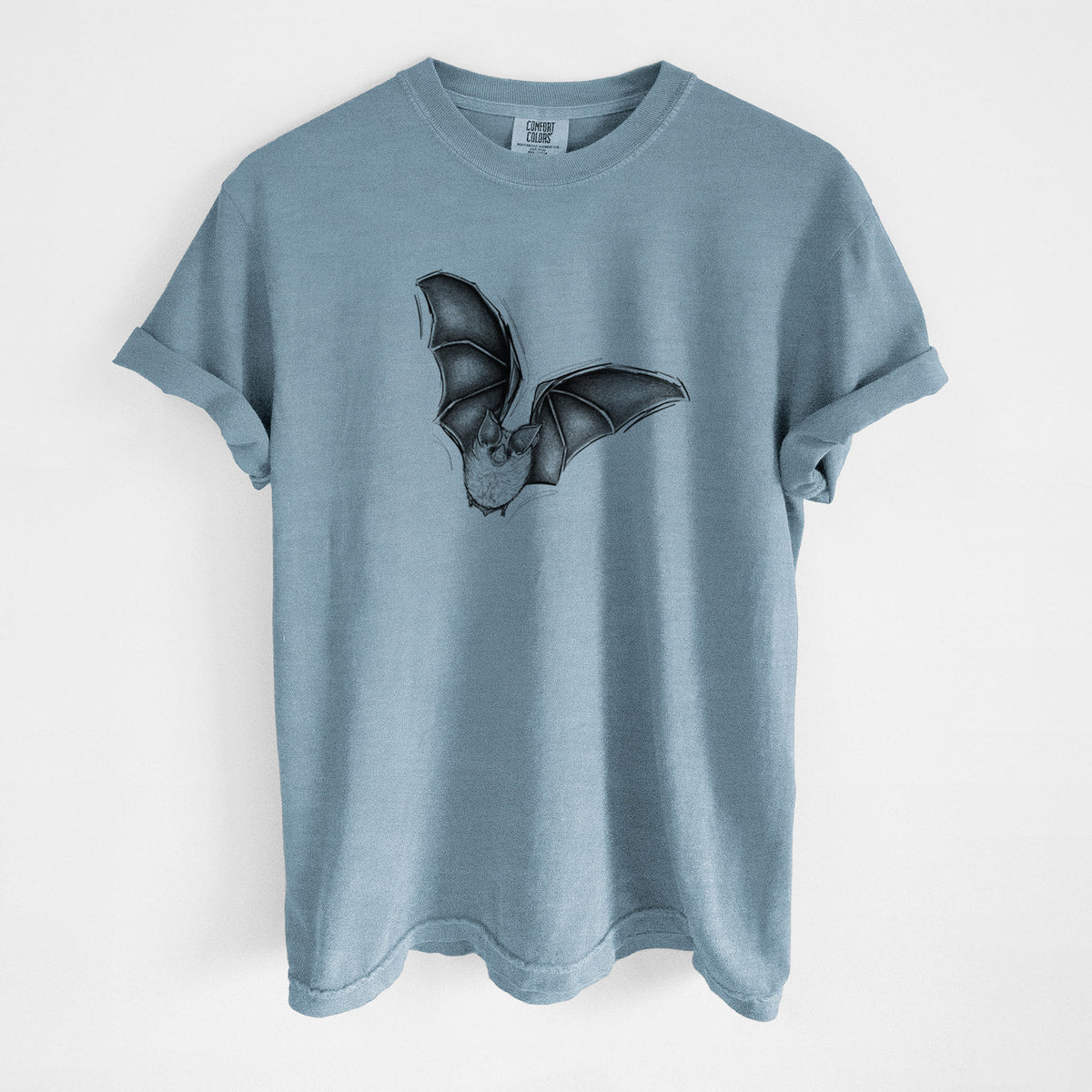 Steel blue Comfort Colors t-shirt laid flat, printed with a detailed black ink illustration of a California leaf-nosed bat in flight.