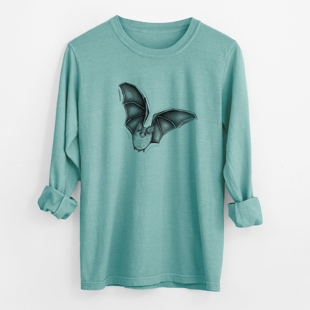 Reef green Comfort Colors long sleeve shirt laid flat with the cuffs rolled, printed with a detailed black ink illustration of a California leaf-nosed bat in flight.