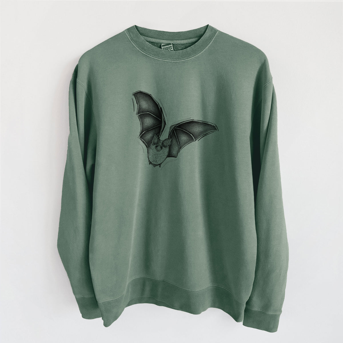 Alpine green pigment dyed crewneck sweatshirt laid flat, printed with a detailed black ink illustration of a California leaf-nosed bat in flight.