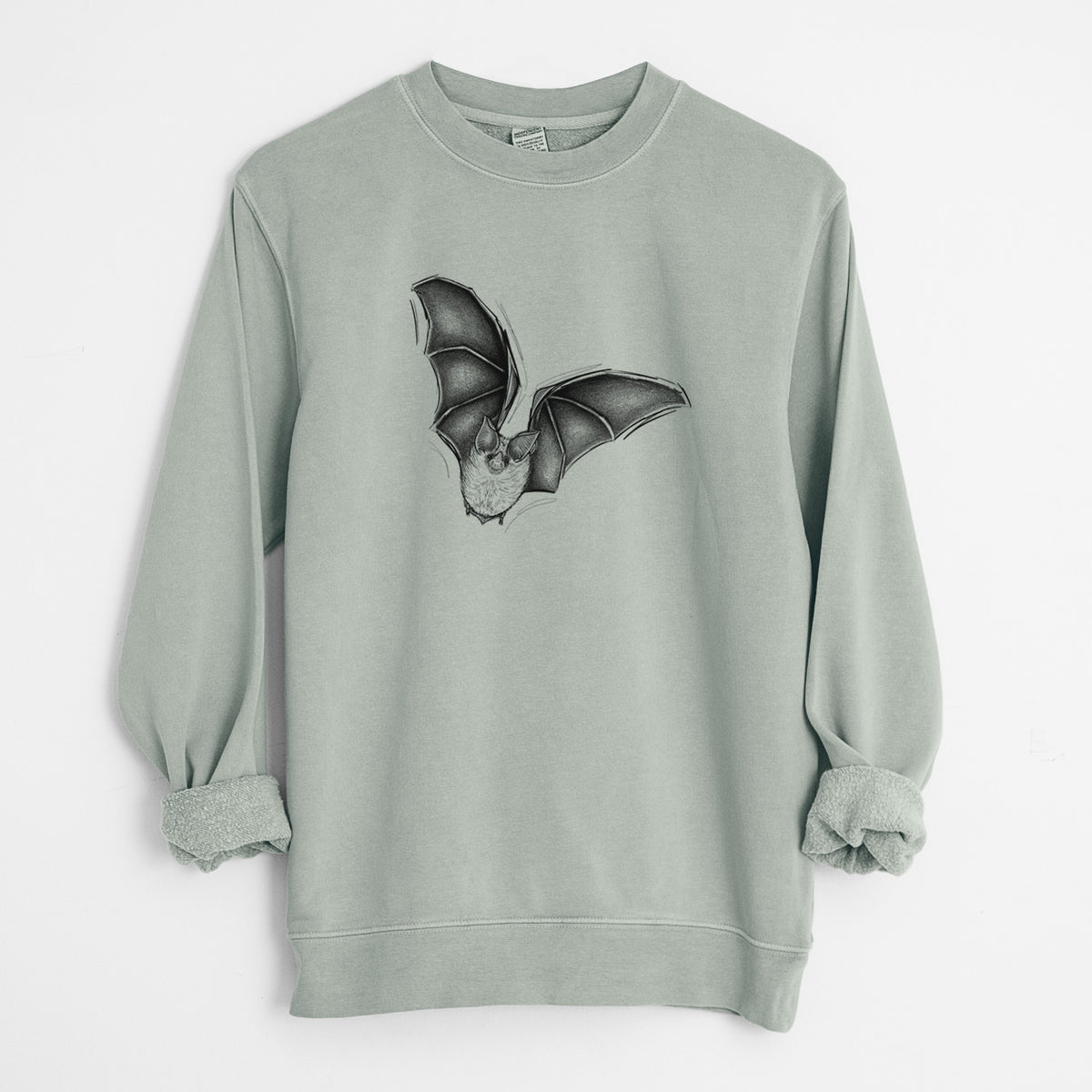 Sage green pigment dyed crewneck sweatshirt laid flat with the sleeves rolled, printed with a detailed black ink illustration of a California leaf-nosed bat in flight.
