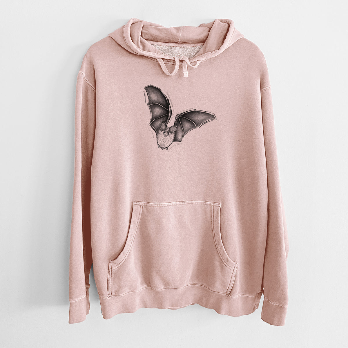 Dusty pink pigment dyed hoodie laid flat, printed with a detailed black ink illustration of a California leaf-nosed bat in flight.