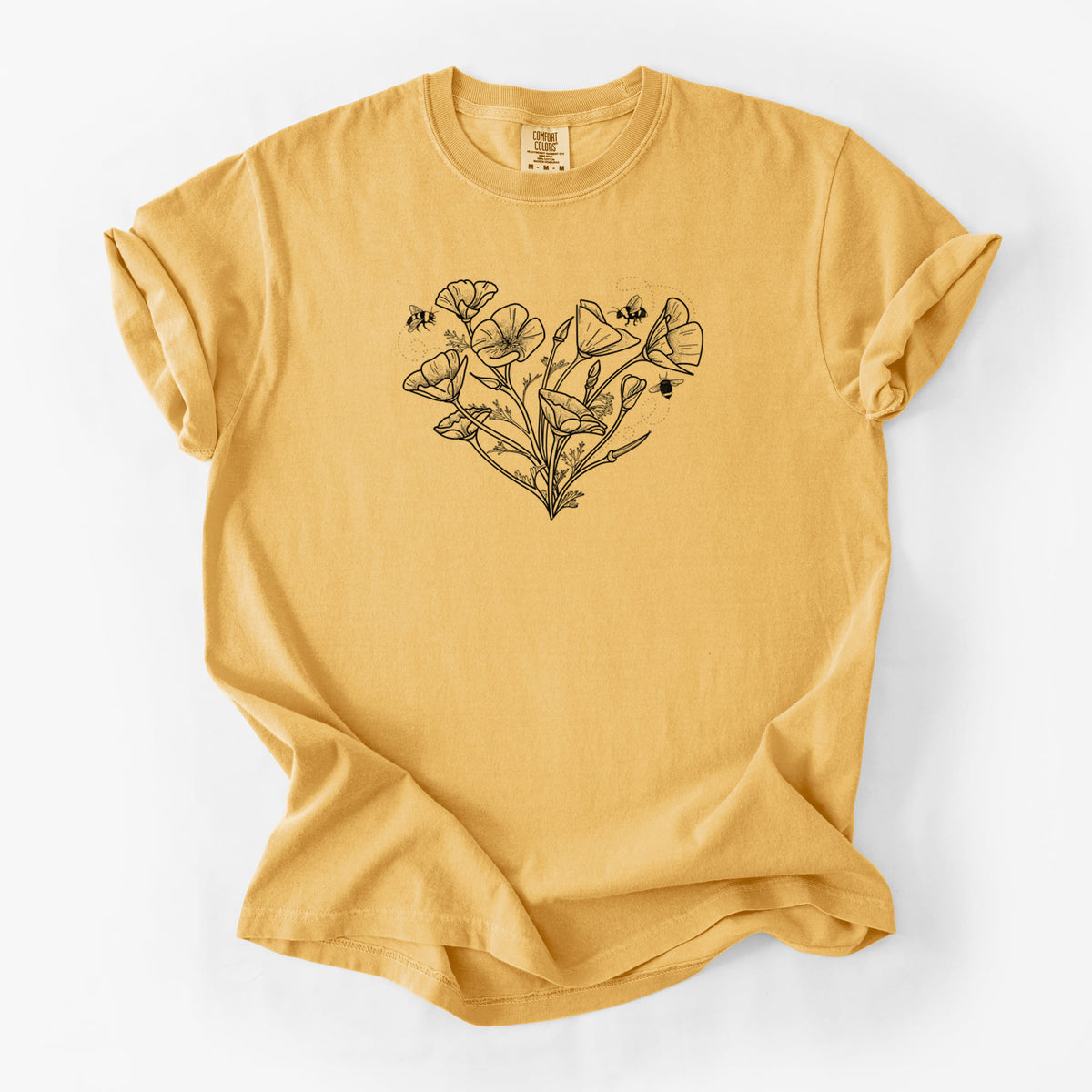 Golden wheat yellow Comfort Colors t-shirt laid flat, printed with a black ink line drawing of California poppies arranged in a heart shape, with small bees.