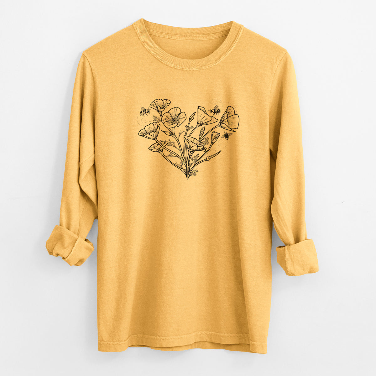 Golden wheat yellow Comfort Colors long sleeve shirt laid flat with the cuffs rolled, printed with a black ink line drawing of California poppies arranged in a heart shape, with small bees.