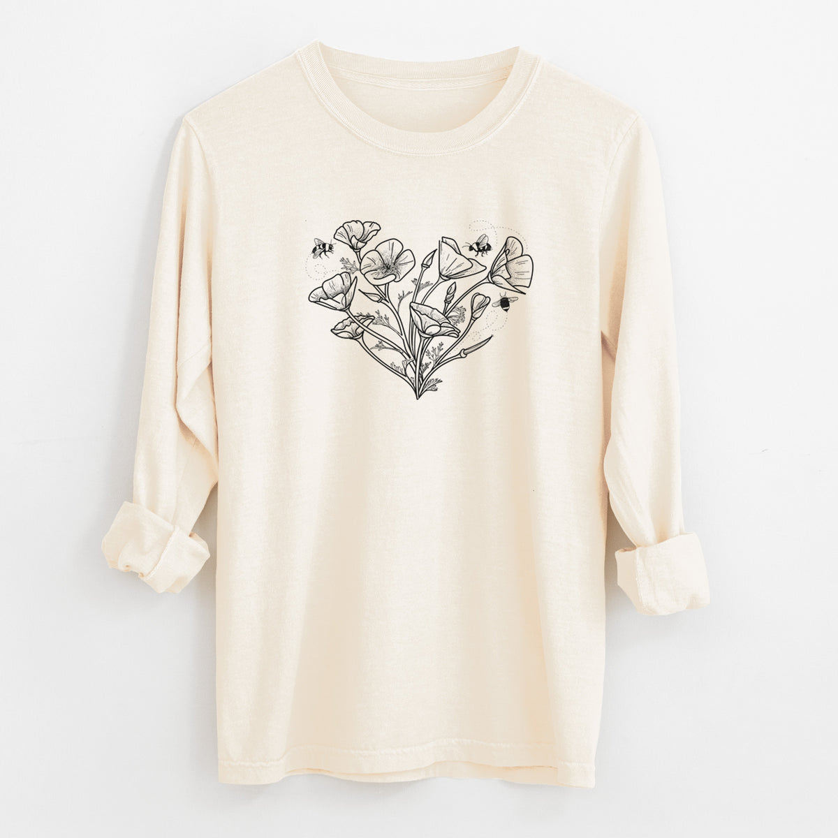 Ivory Comfort Colors long sleeve shirt laid flat with the cuffs rolled, printed with a black ink line drawing of California poppies arranged in a heart shape, with small bees.
