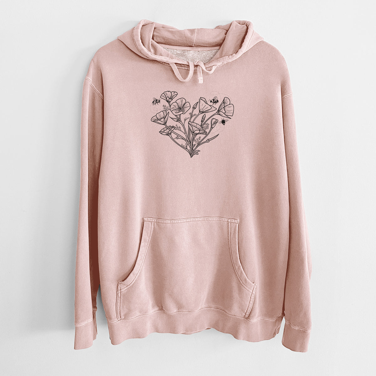Dusty pink pigment dyed hoodie laid flat, printed with a black ink line drawing of California poppies arranged in a heart shape, with small bees.