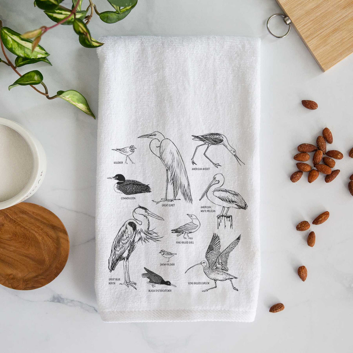White hand towel printed with a chart of black ink California shorebirds, including herons, egrets, avocets and sandpipers.