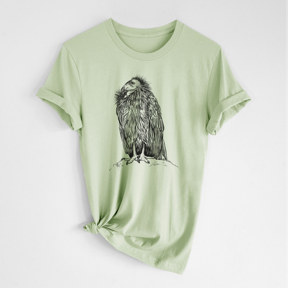 Spring green lightweight cotton t-shirt laid flat with the sleeves rolled, printed with a detailed black ink illustration of a California condor perched with folded wings.