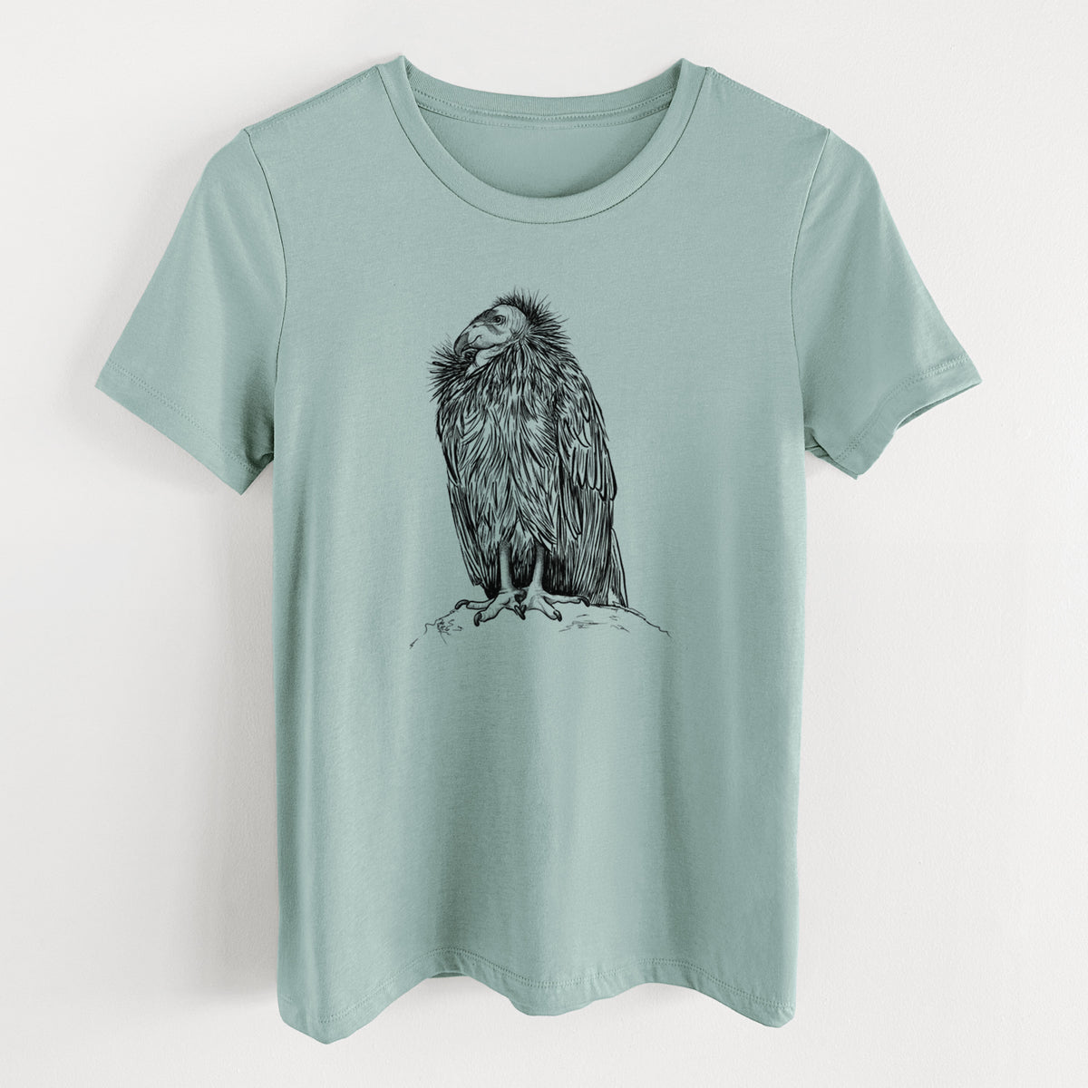 Dusty blue women's relaxed fit cotton t-shirt laid flat, printed with a detailed black ink illustration of a California condor perched with folded wings.