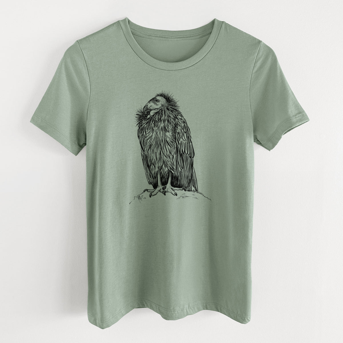 Sage green women's relaxed fit cotton t-shirt laid flat, printed with a detailed black ink illustration of a California condor perched with folded wings.