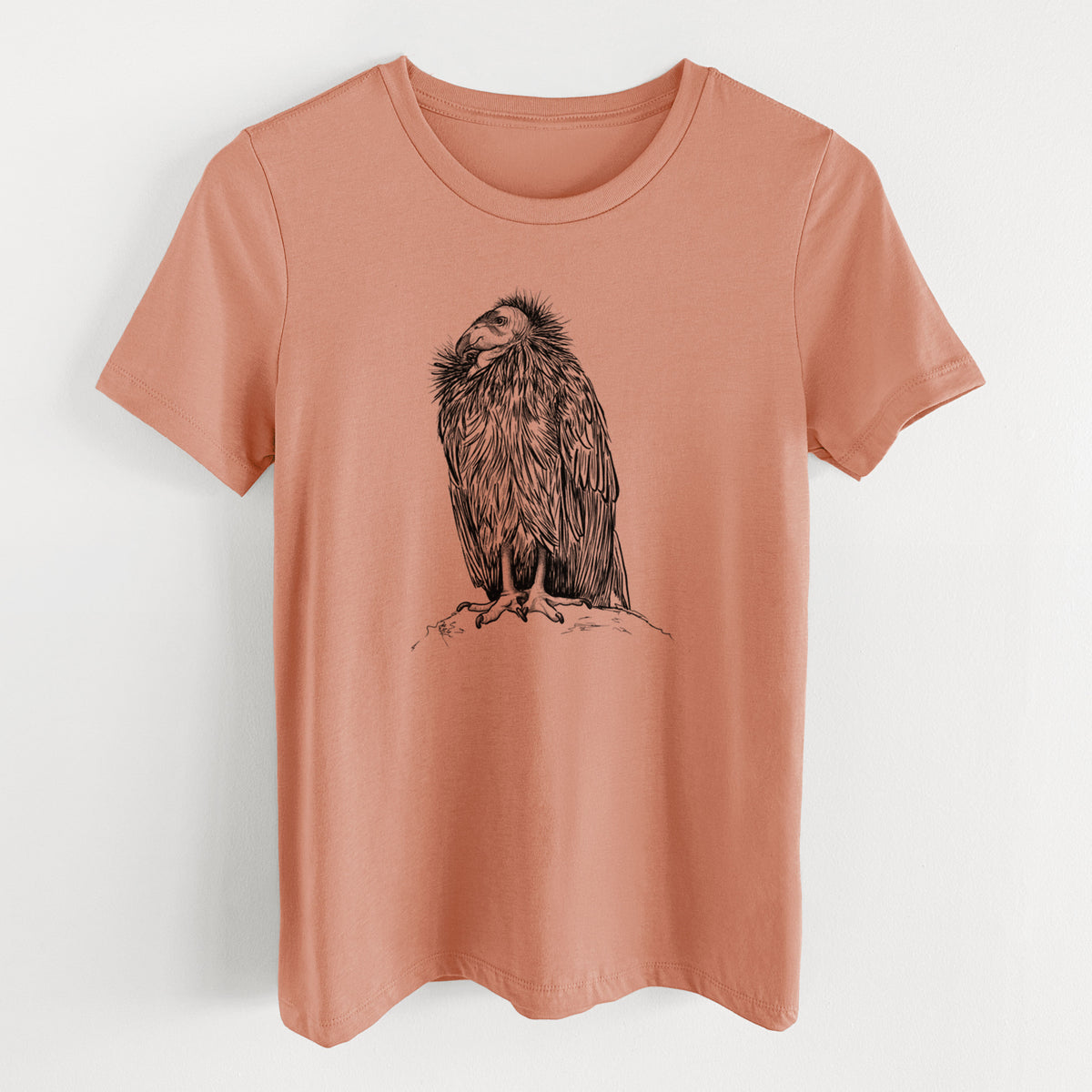 Terracotta orange women's relaxed fit cotton t-shirt laid flat, printed with a detailed black ink illustration of a California condor perched with folded wings.