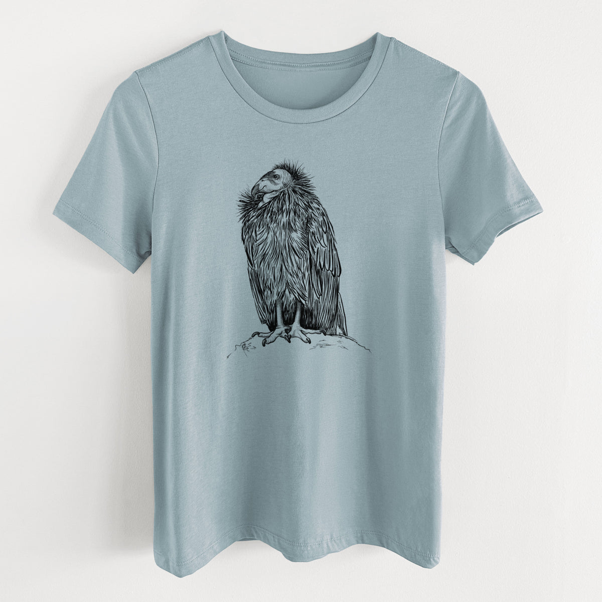 Vintage denim women's relaxed fit cotton t-shirt laid flat, printed with a detailed black ink illustration of a California condor perched with folded wings.