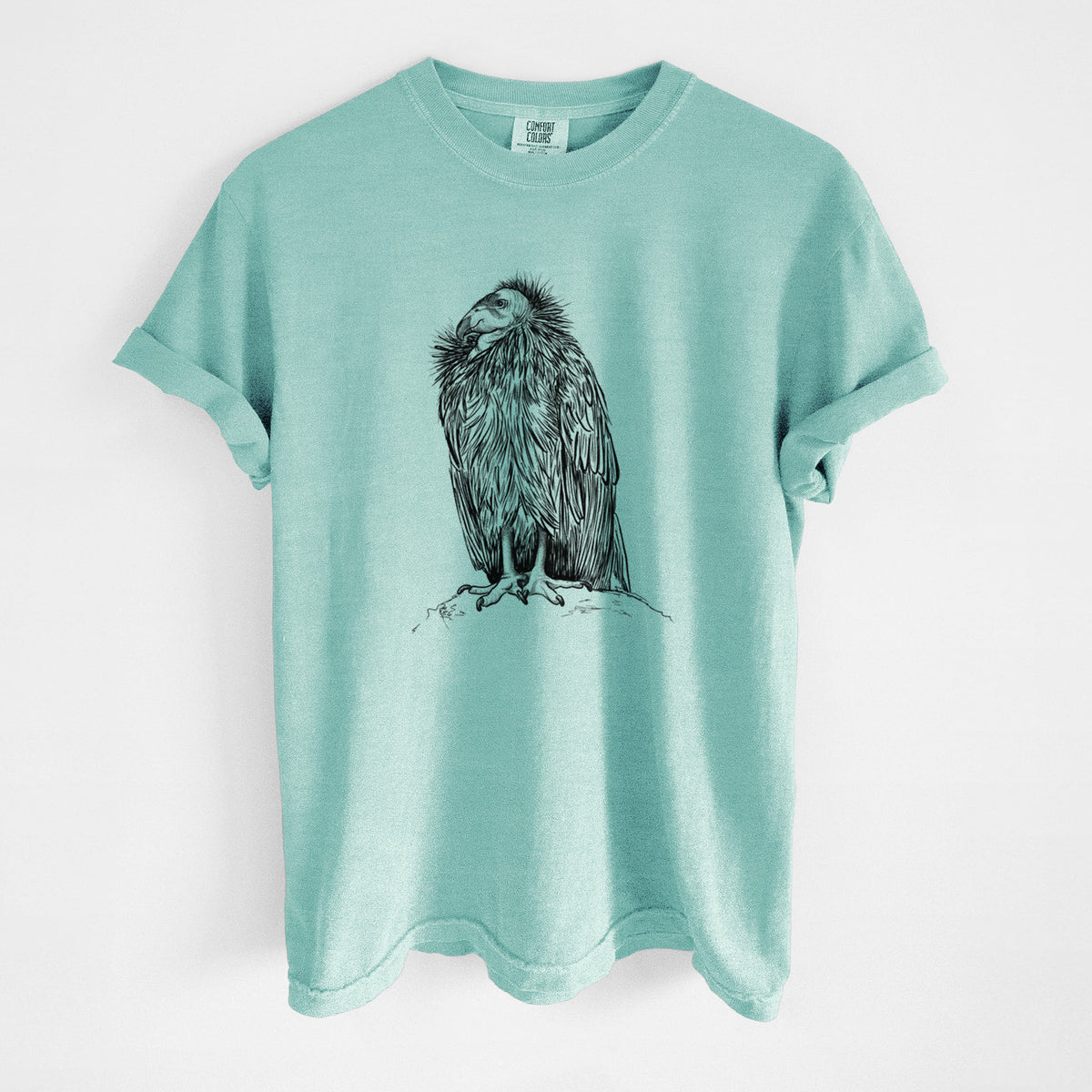 Chalky mint Comfort Colors t-shirt laid flat, printed with a detailed black ink illustration of a California condor perched with folded wings.