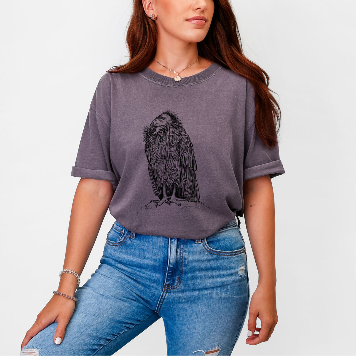 Woman wearing a Comfort Colors t-shirt printed with a detailed black ink illustration of a California condor perched with folded wings.