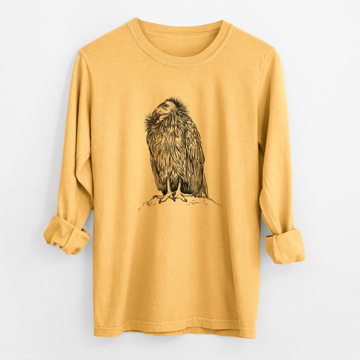 Golden wheat yellow Comfort Colors long sleeve shirt laid flat with the cuffs rolled, printed with a detailed black ink illustration of a California condor perched with folded wings.