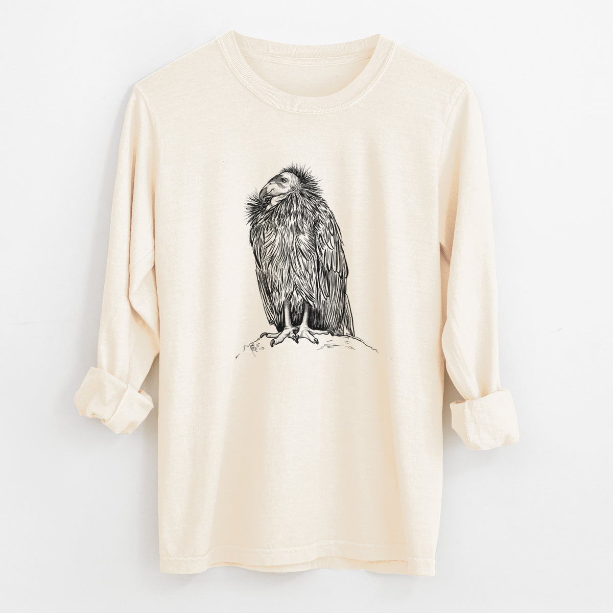 Ivory Comfort Colors long sleeve shirt laid flat with the cuffs rolled, printed with a detailed black ink illustration of a California condor perched with folded wings.