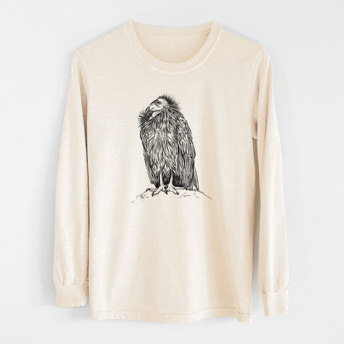 Ivory Comfort Colors long sleeve shirt laid flat, printed with a detailed black ink illustration of a California condor perched with folded wings.