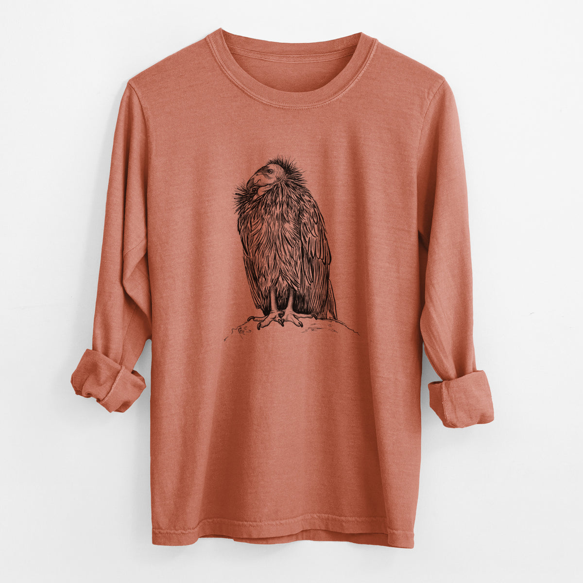 Yam burnt orange Comfort Colors long sleeve shirt laid flat with the cuffs rolled, printed with a detailed black ink illustration of a California condor perched with folded wings.