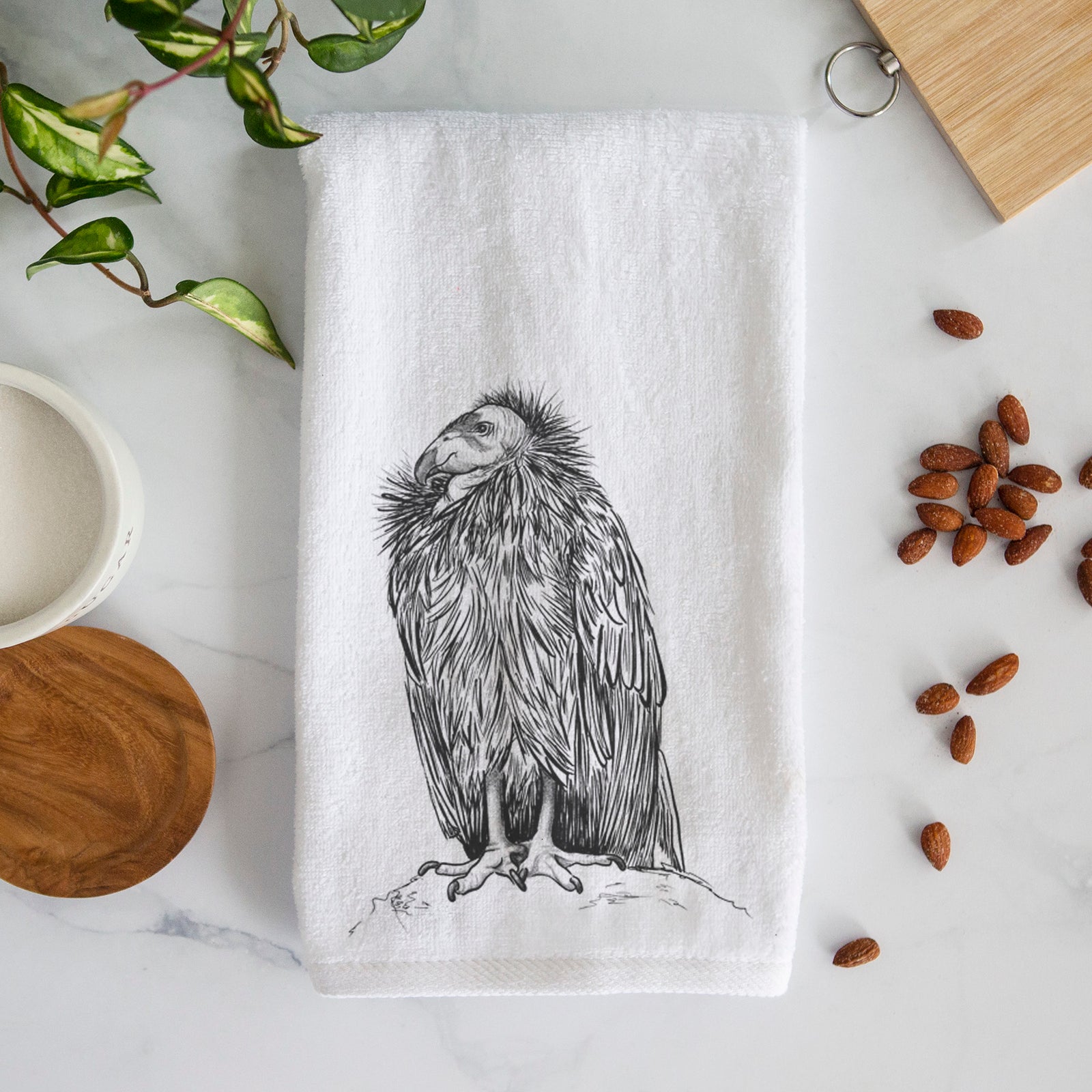 White hand towel printed with a detailed black ink illustration of a California condor perched with folded wings.