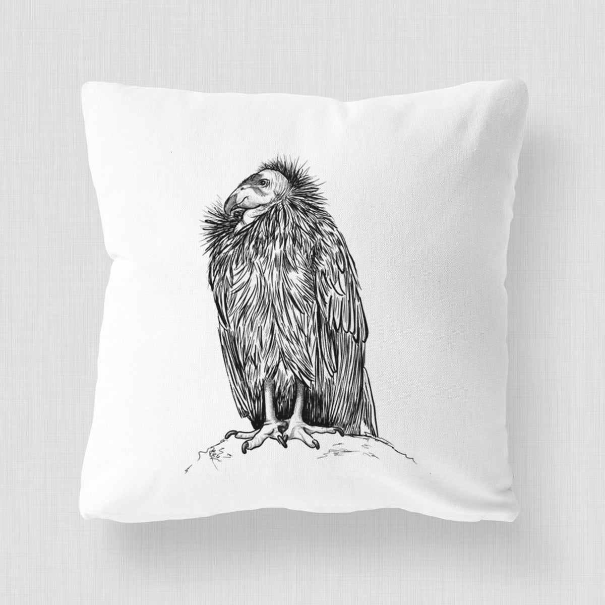 White pillow cover printed with a detailed black ink illustration of a California condor perched with folded wings.