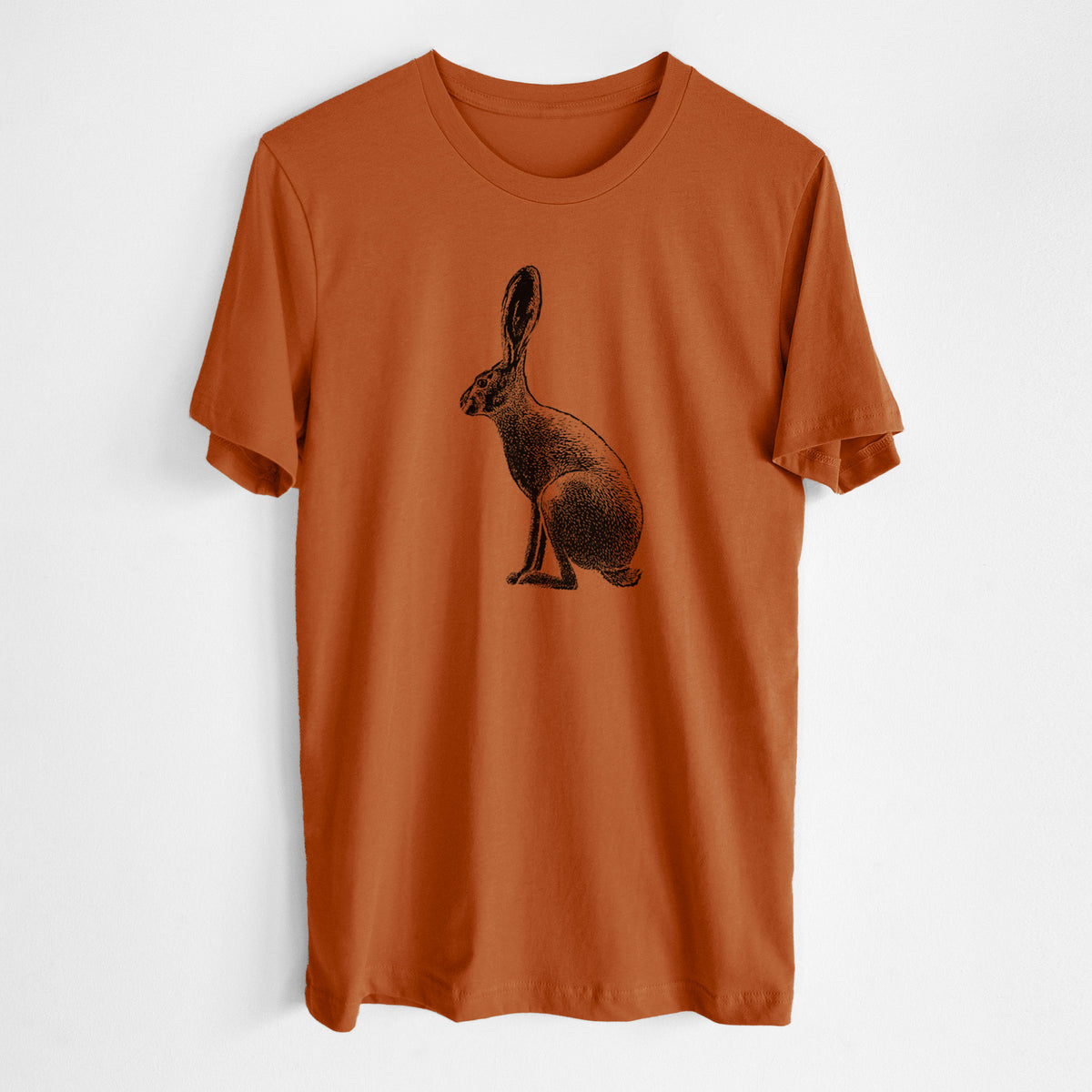 Autumn lightweight cotton t-shirt laid flat, printed with a detailed black ink illustration of a black-tailed jackrabbit sitting in profile with tall ears.