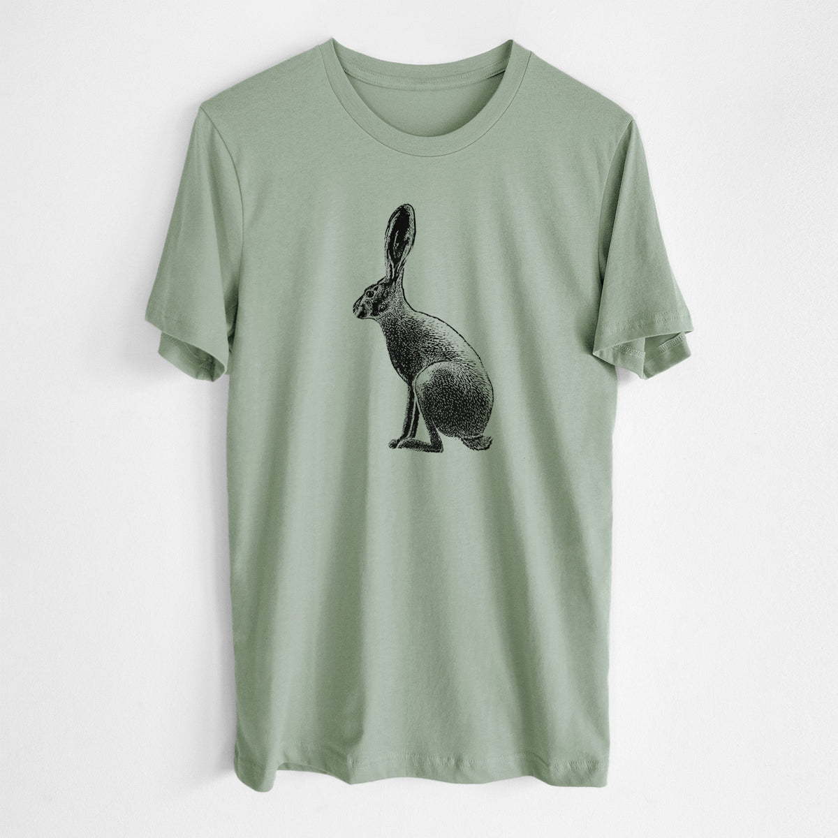 Sage green lightweight cotton t-shirt laid flat, printed with a detailed black ink illustration of a black-tailed jackrabbit sitting in profile with tall ears.