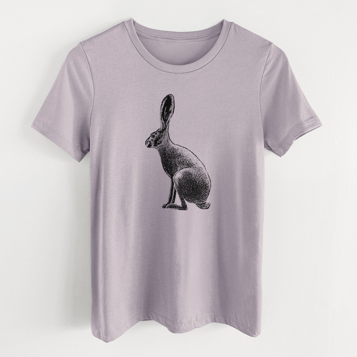 Light violet women's relaxed fit cotton t-shirt laid flat, printed with a detailed black ink illustration of a black-tailed jackrabbit sitting in profile with tall ears.