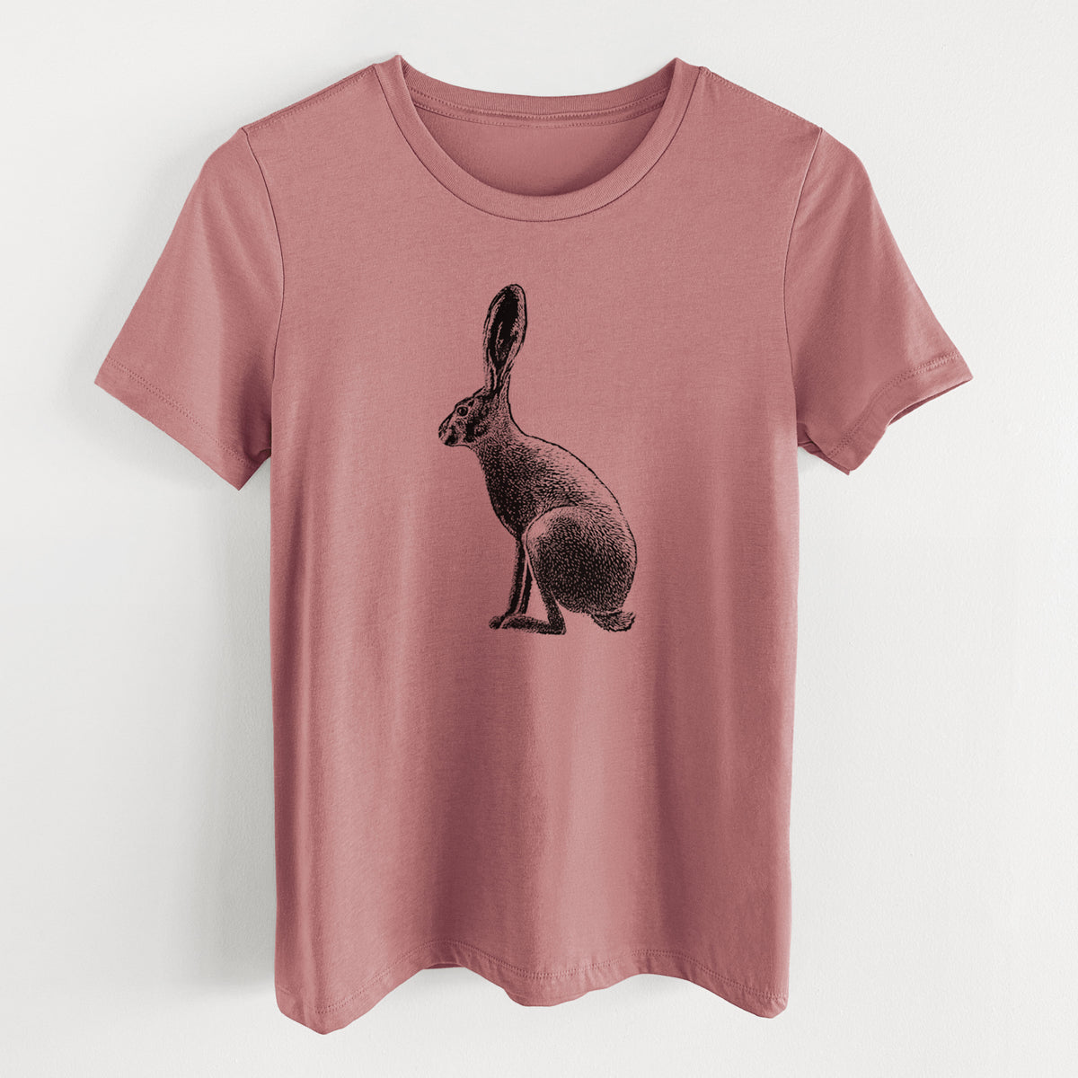 Mauve pink women's relaxed fit cotton t-shirt laid flat, printed with a detailed black ink illustration of a black-tailed jackrabbit sitting in profile with tall ears.