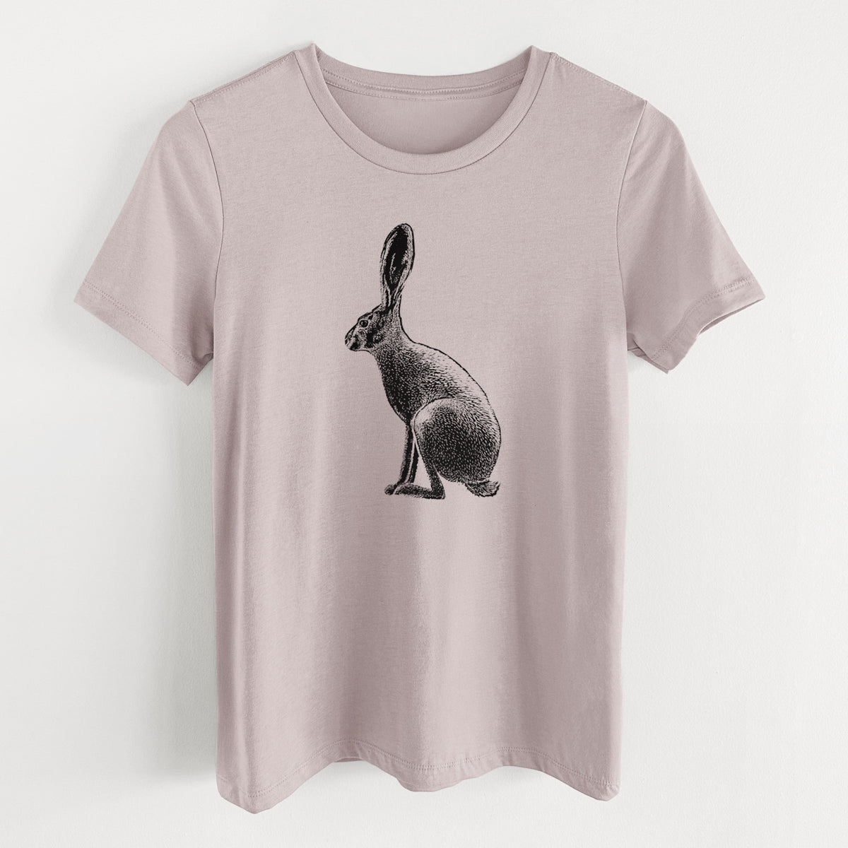 Pink gravel women's relaxed fit cotton t-shirt laid flat, printed with a detailed black ink illustration of a black-tailed jackrabbit sitting in profile with tall ears.