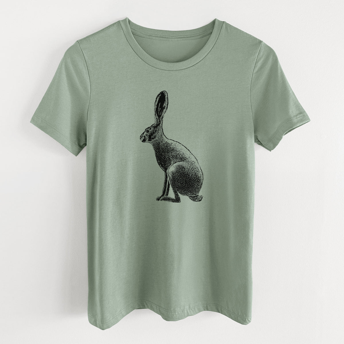 Sage green women's relaxed fit cotton t-shirt laid flat, printed with a detailed black ink illustration of a black-tailed jackrabbit sitting in profile with tall ears.