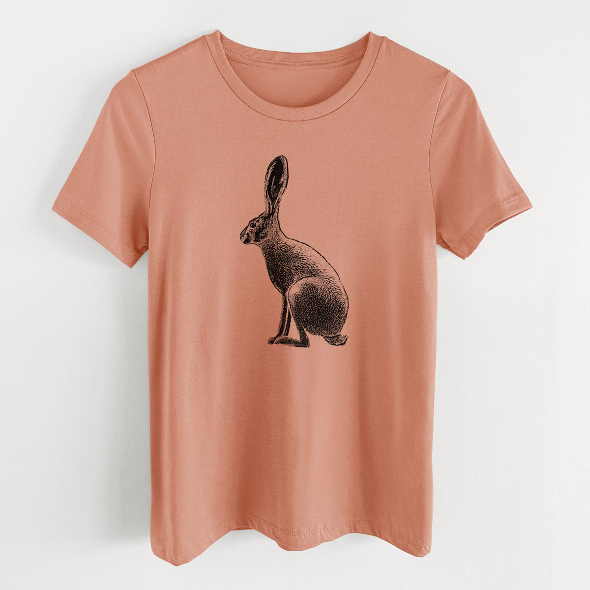 Terracotta orange women's relaxed fit cotton t-shirt laid flat, printed with a detailed black ink illustration of a black-tailed jackrabbit sitting in profile with tall ears.