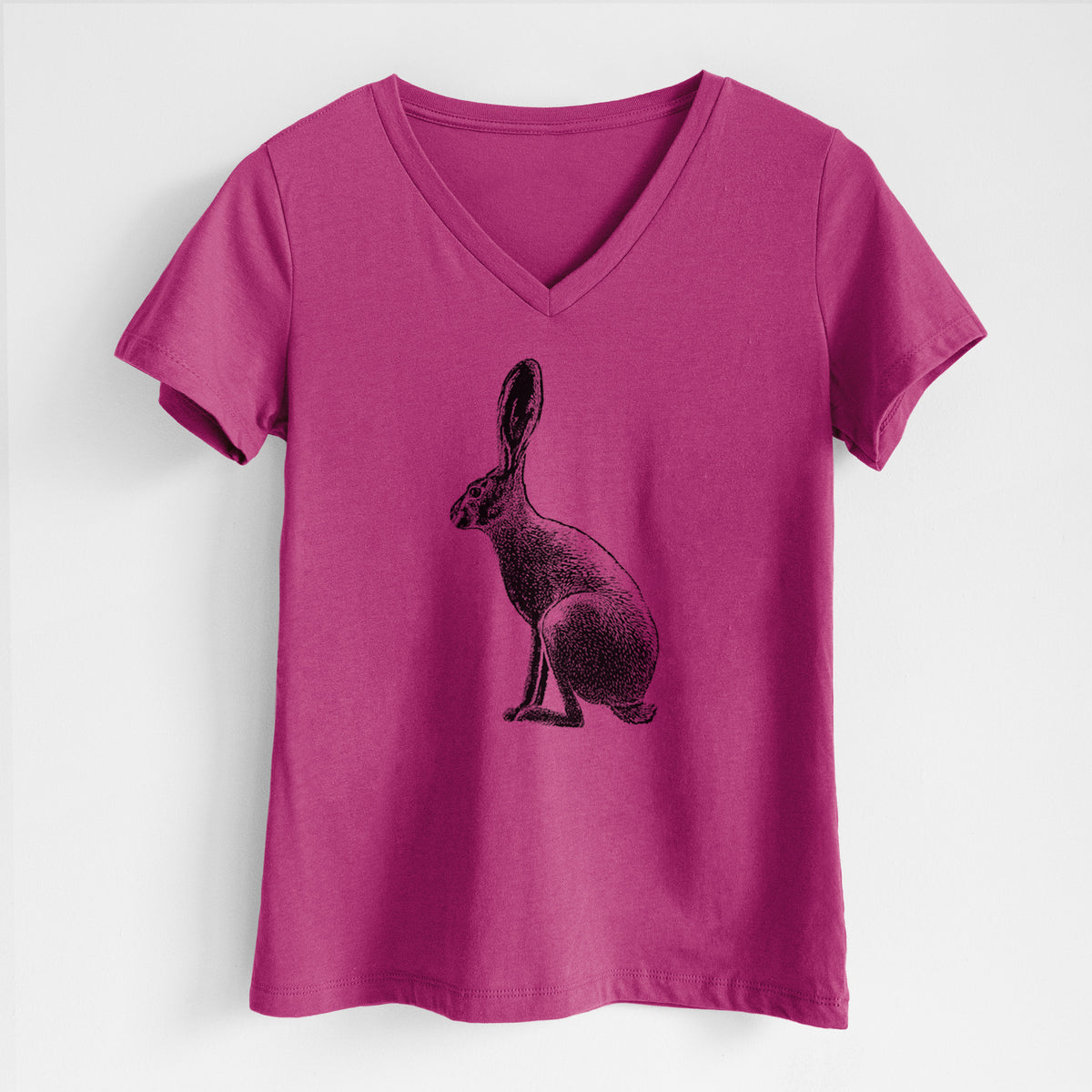Berry pink women's relaxed fit cotton V-neck t-shirt laid flat, printed with a detailed black ink illustration of a black-tailed jackrabbit sitting in profile with tall ears.